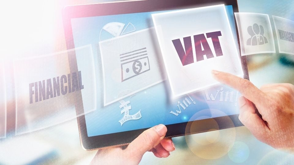 (In the image a businessman can be seen paying VAT in pounds)