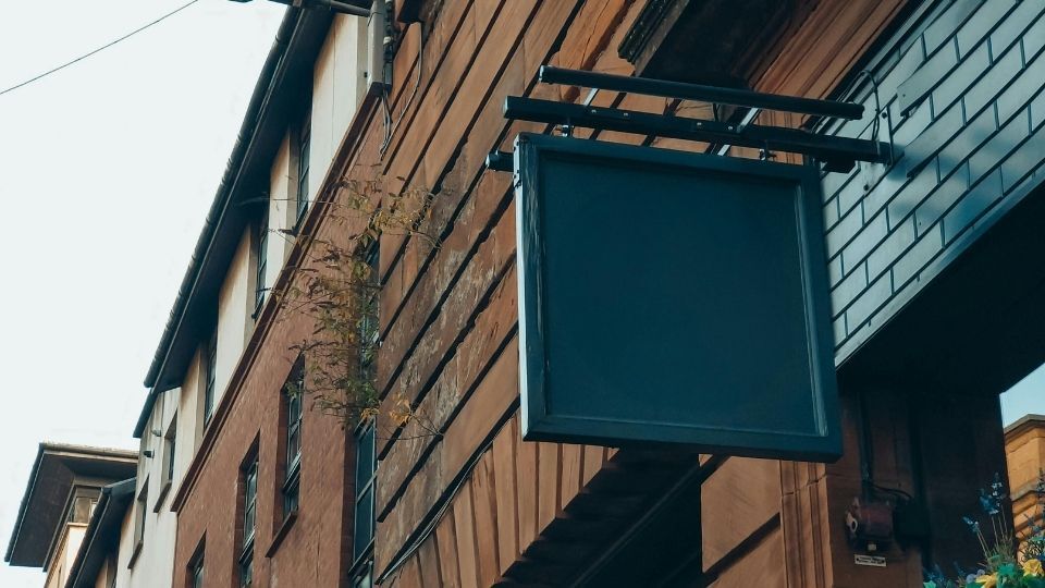 The Power of Storefront Signs: Attracting Customers with Eye-Catching Designs 1 (In the image an eye-catching storefront sign can be seen hanging)