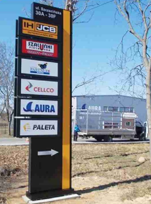 Multi-tenant totem sign displaying multiple business logos outdoors