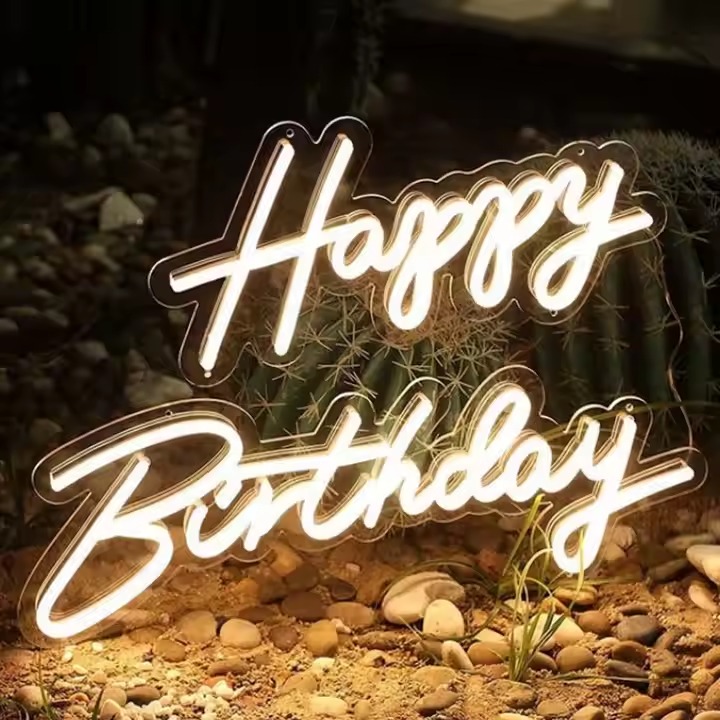 Neon signs displaying a Happy Birthday message in warm white LED lighting for indoor decor