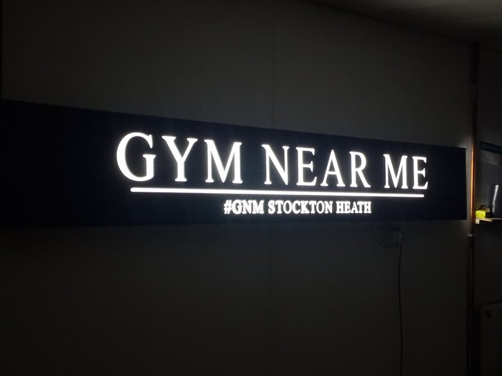 Illuminated fascia tray sign for a gym, showcasing outdoor business signs designed and installed by Manchester Signs Centre