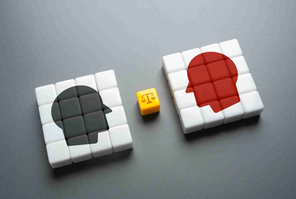 Two cubes displaying contrasting figures to represent Alternative Dispute Resolution HMRC and the balance between opposing tax dispute outcomes.