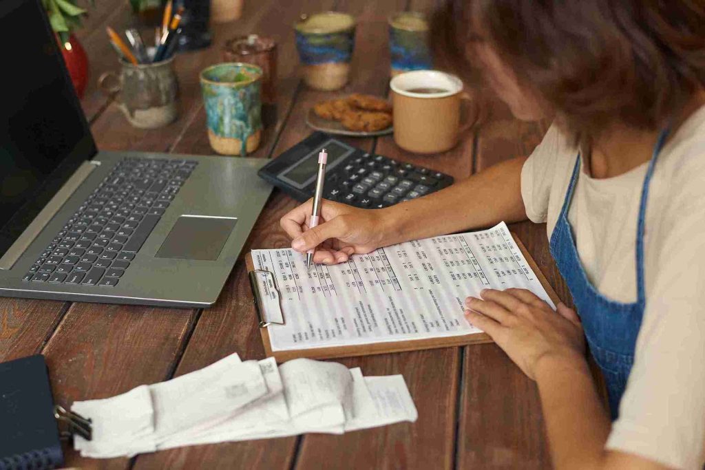 A woman managing her finances while receiving small business tax advice.