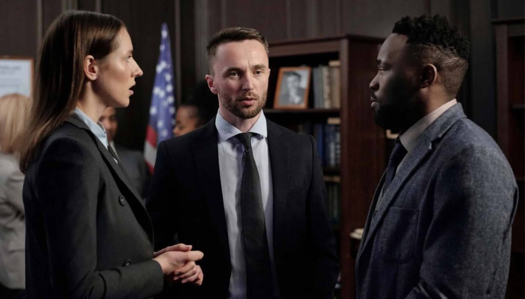 Airbnb hosts or property managers discussing the impact of new airbnb regulations uk with legal counsel.