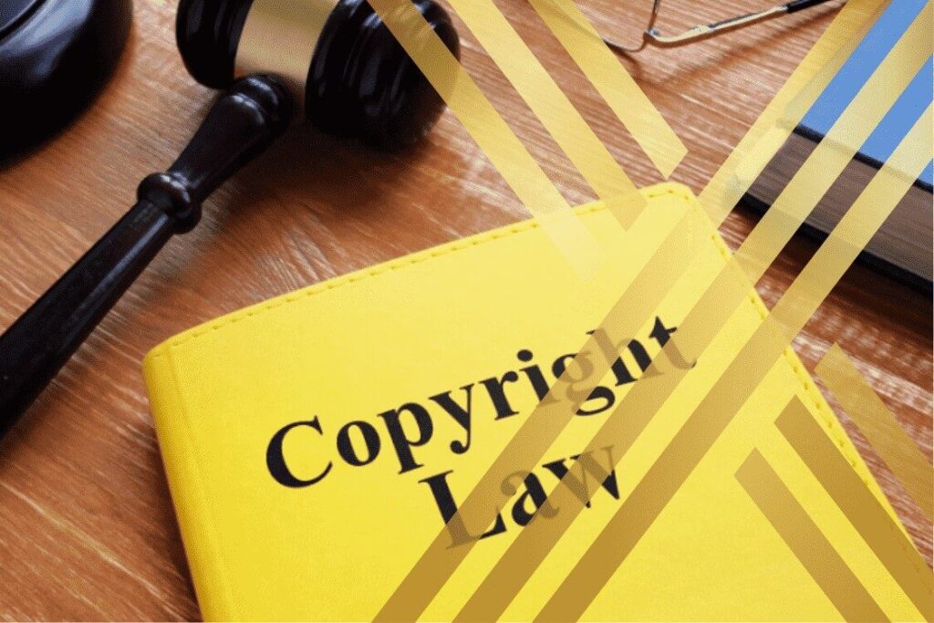 Gavel on a yellow book titled "Copyright Law," symbolizing legal enforcement of copyright protection.