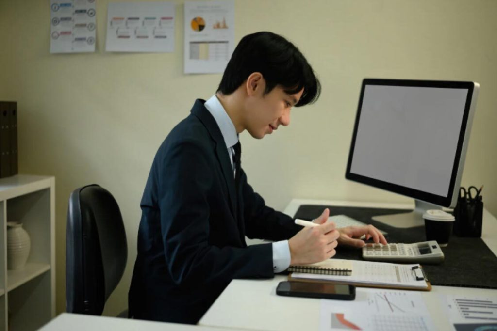 (A small business owner reviewing taxable profits and corporation tax rate on a computer to ensure HMRC compliance.)how much is corporation tax