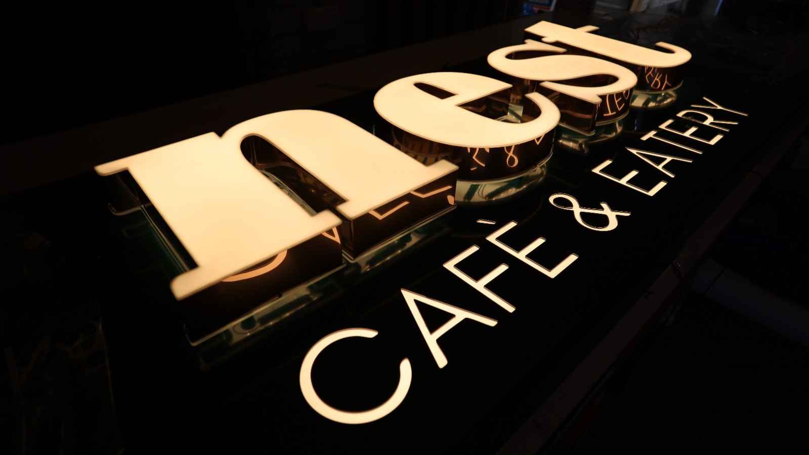 Nest cafe sign