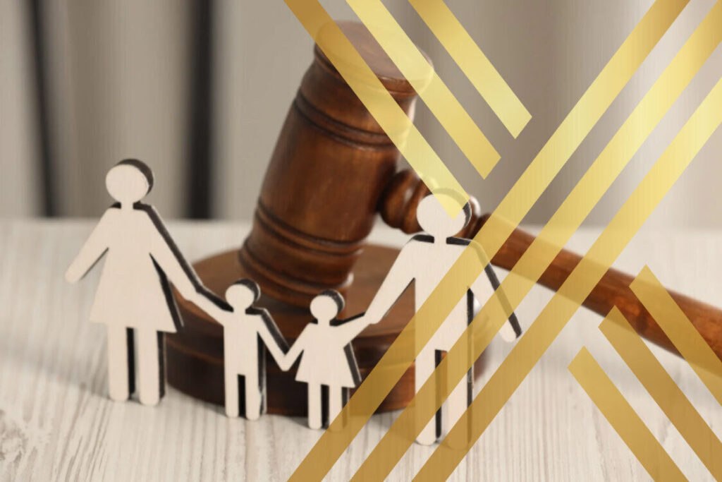 Family cutouts in front of a court gavel, representing parental rights and family law disputes.