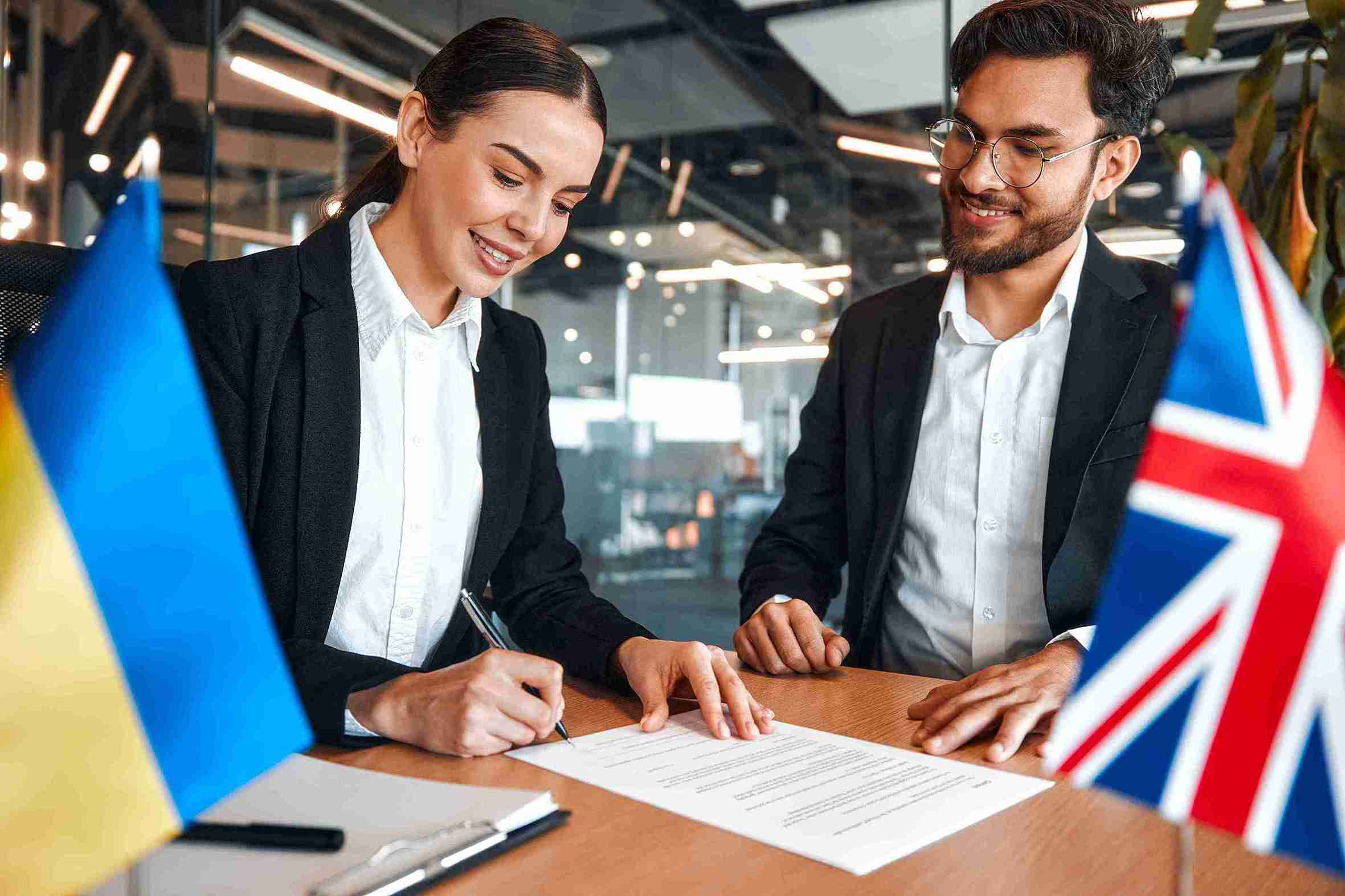 business professionals signing a contract, symbolizing collaboration and partnership in business development.