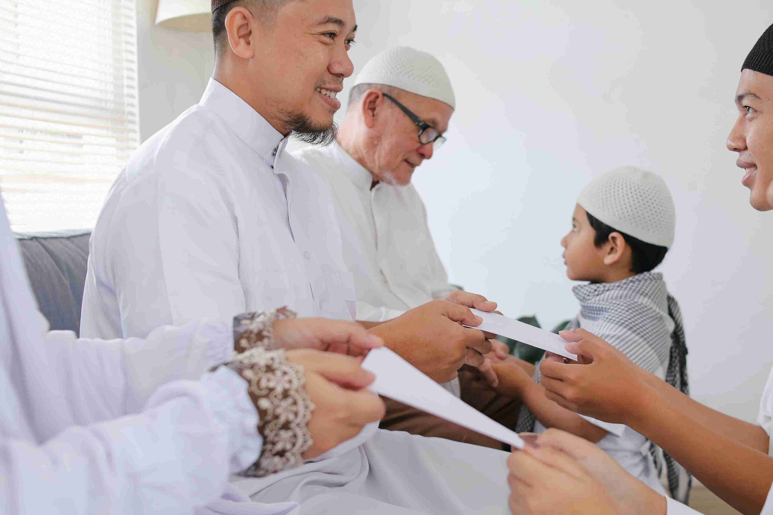 Men and children in traditional white attire giving envelopes indoors, representing waqf and Islamic trusts.