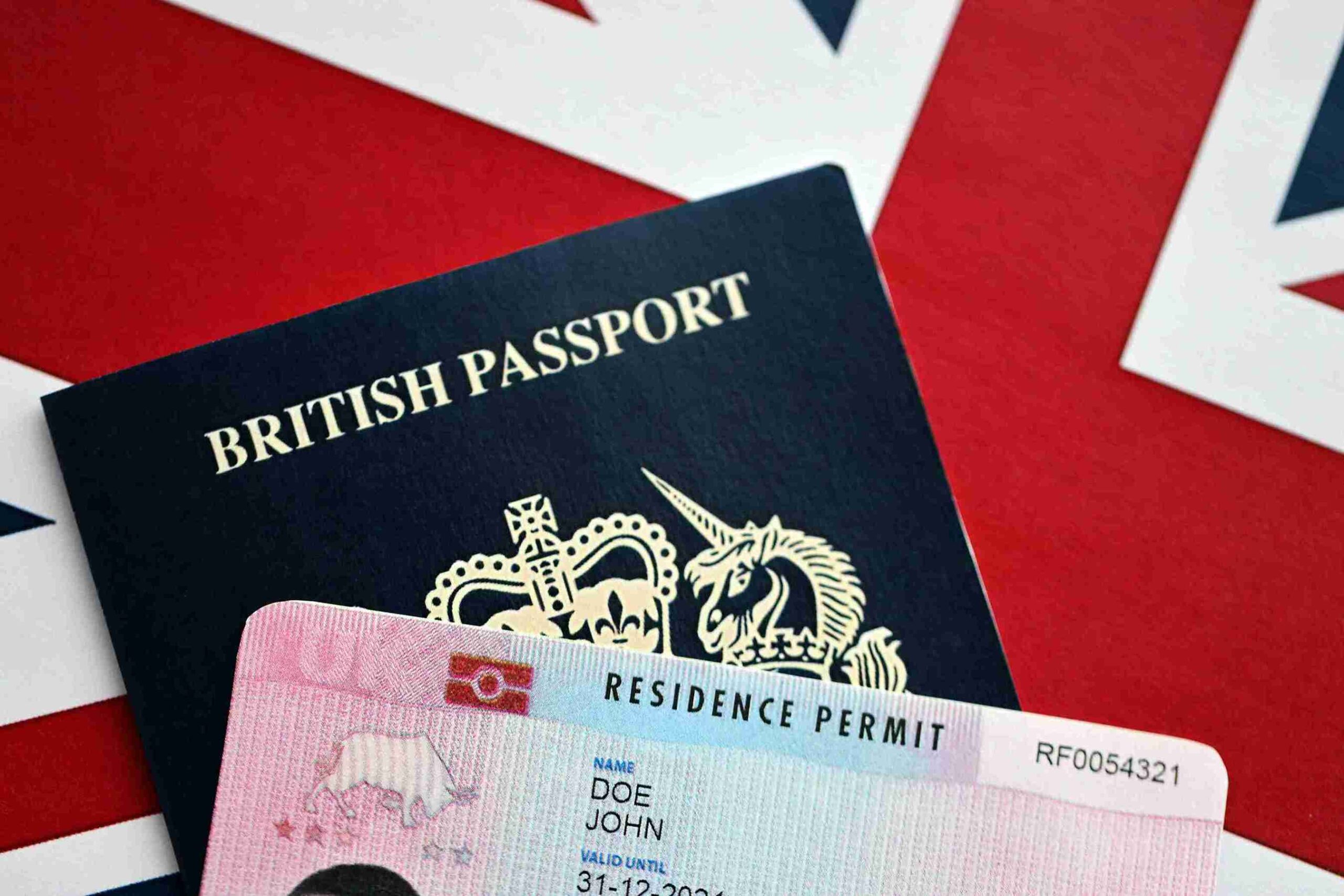 British passport displayed on a surface, showcasing its cover and emblem, symbolizing British citizenship and identity.