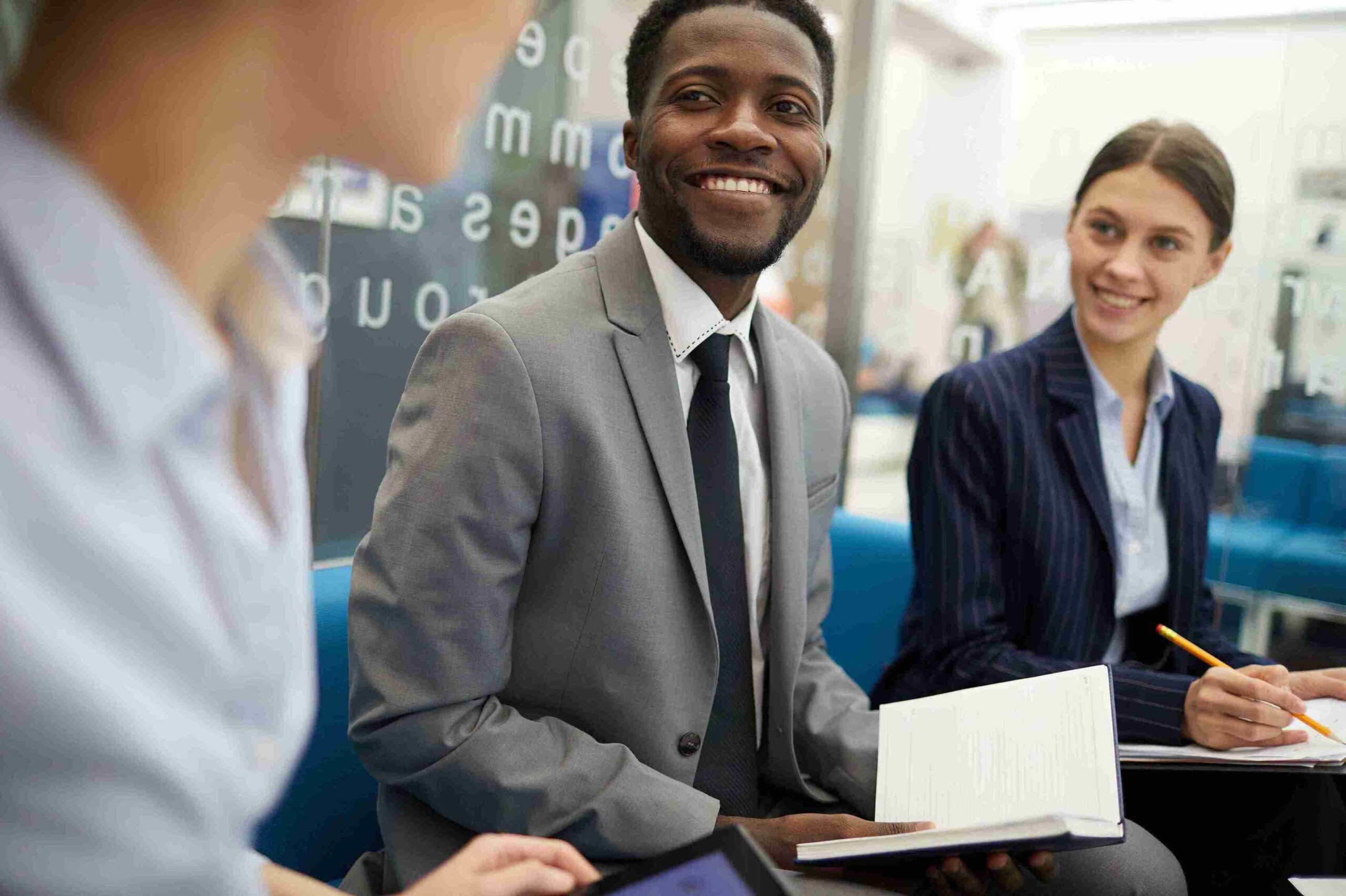 A man and woman in business attire sit in an office, discussing ideas related to Start-Up UK