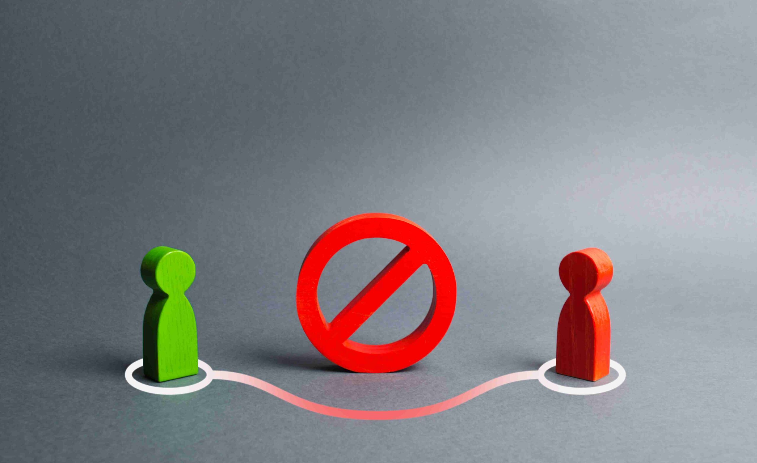 Red and green sign about boundary and ownership disputes, with a group of people discussing around it.