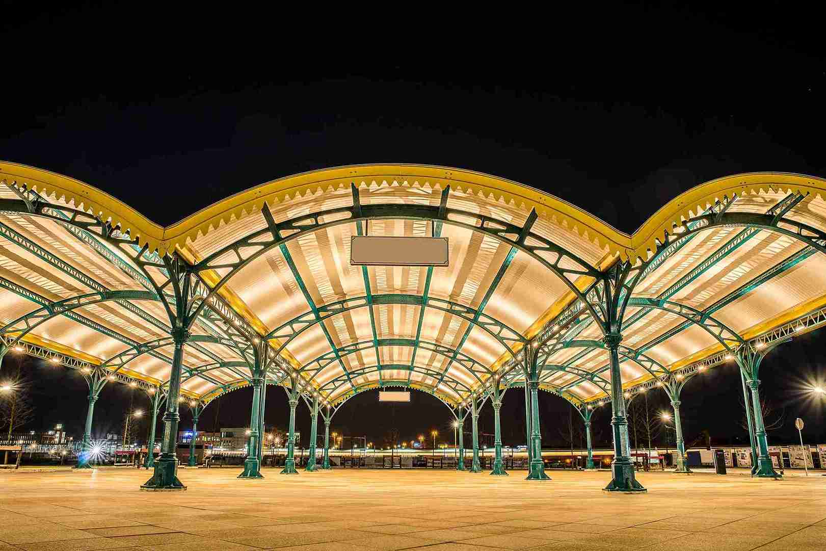 wide angle shot of a yellow roof supported by gree