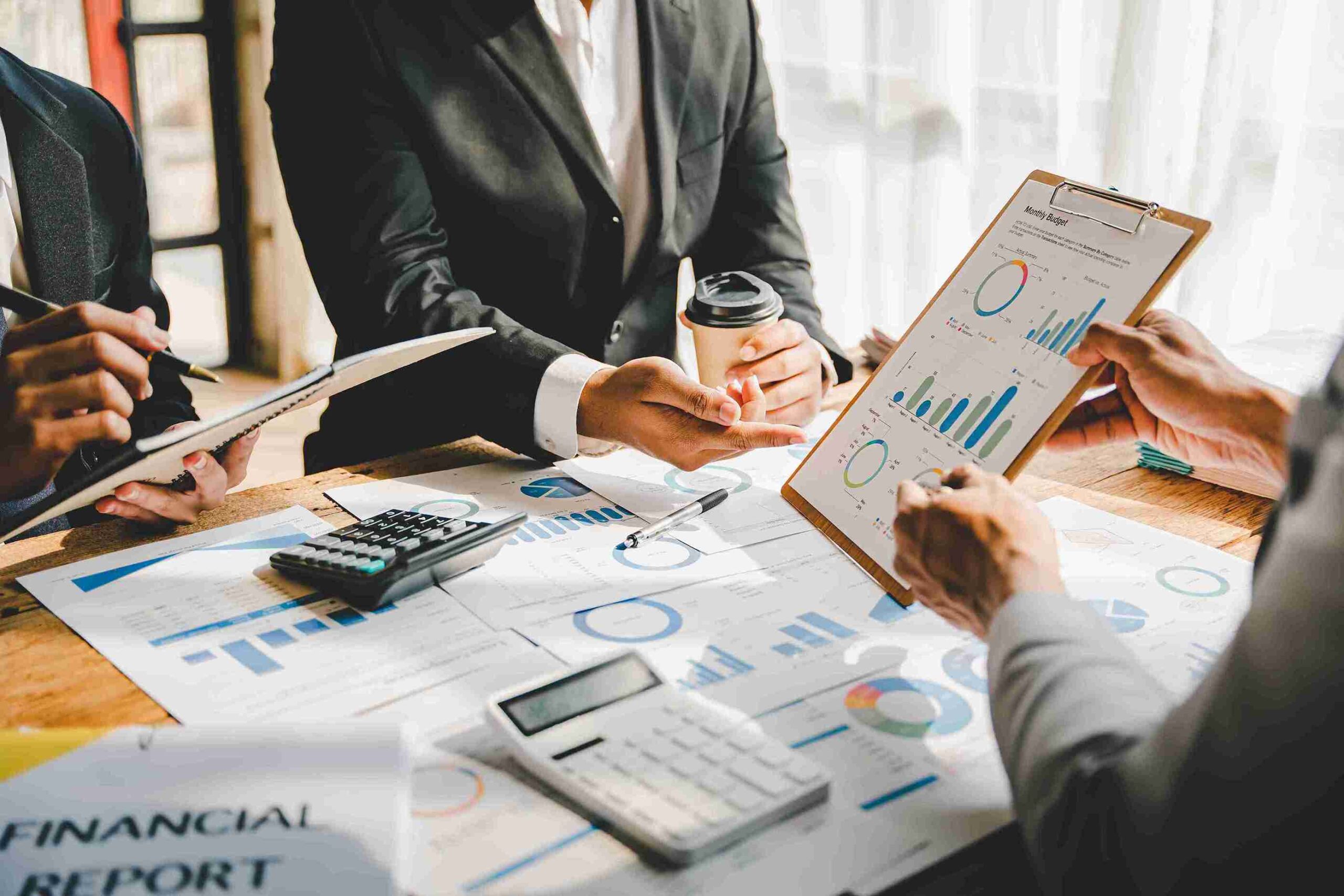 Business team reviewing financial charts and reports, representing professional VAT inspection improve compliance, and strengthen financial practices.