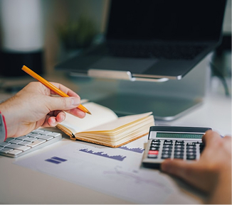 Accountant is calculating something and writing it on paper