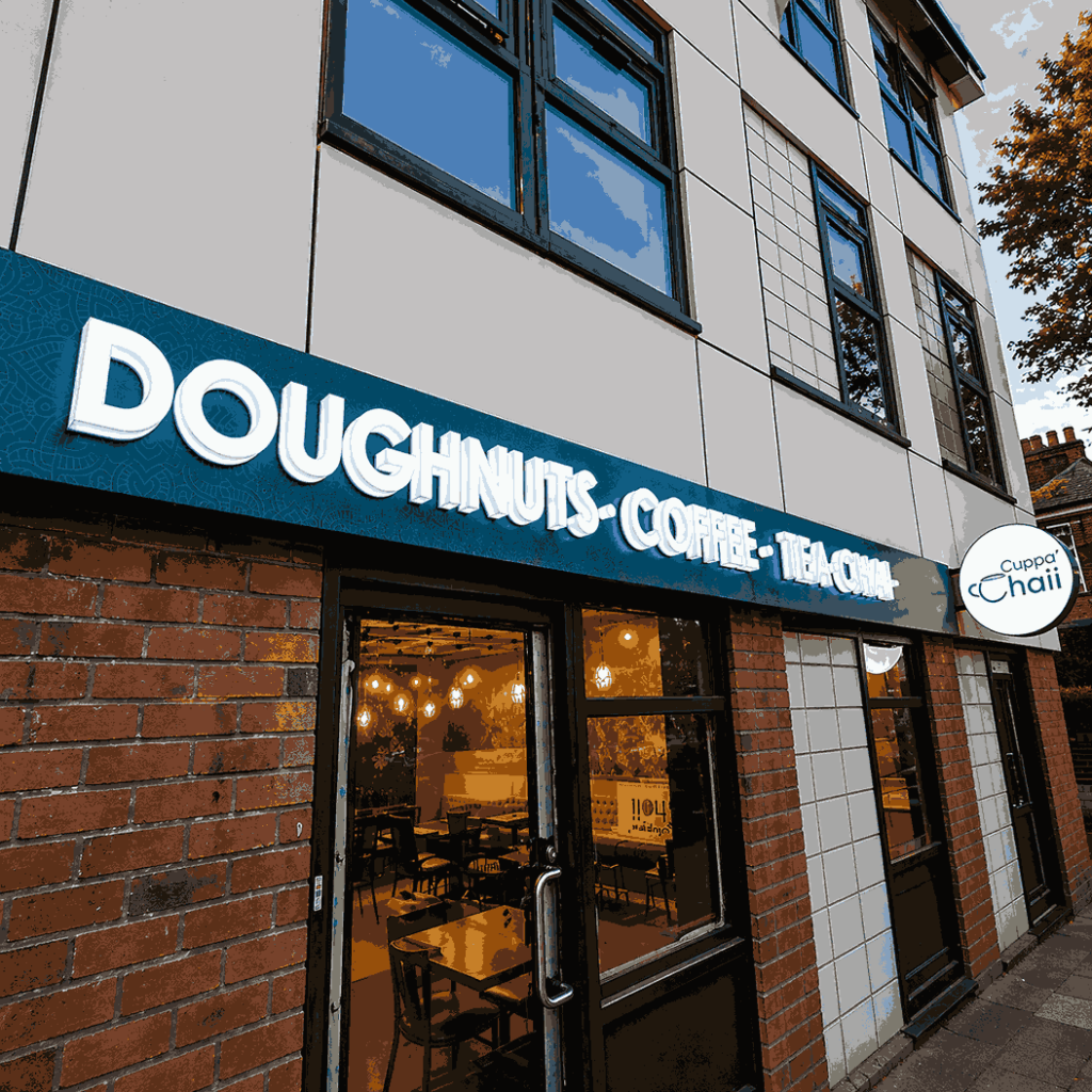 A building featuring a sign that reads "Doughnuts and Coffee," inviting customers to enjoy sweet treats and beverages.