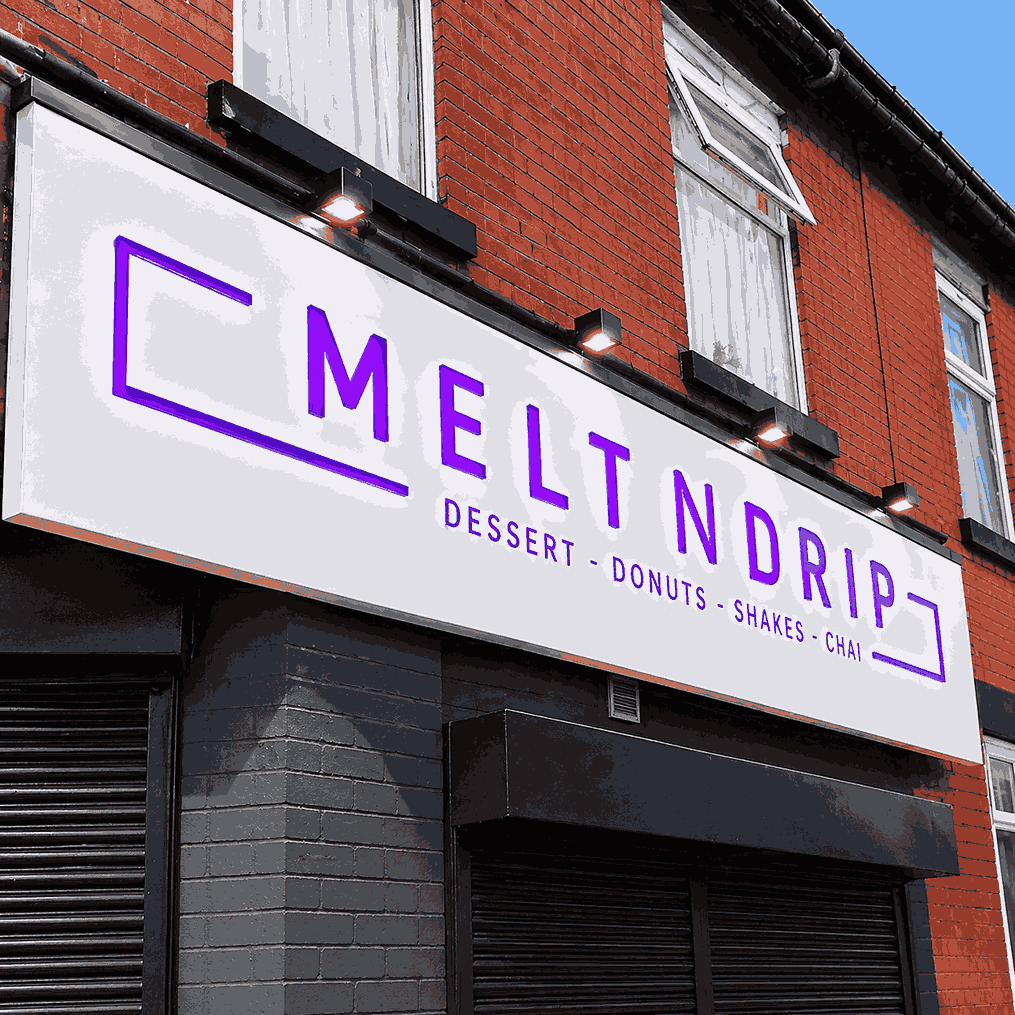 A sign displaying the words "Melt N Drip" in bold, colorful letters against a simple background.