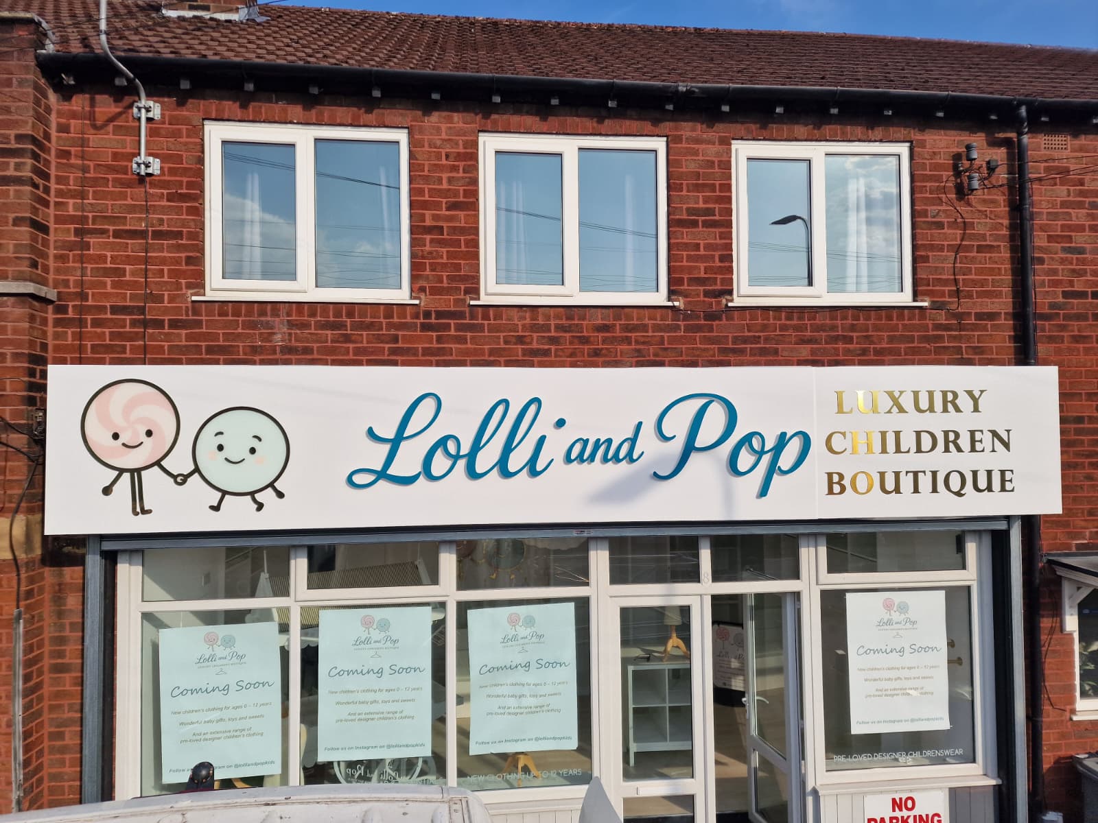 Colorful storefront of Lolli and Pop children's boutique, showcasing playful clothing and accessories for kids.