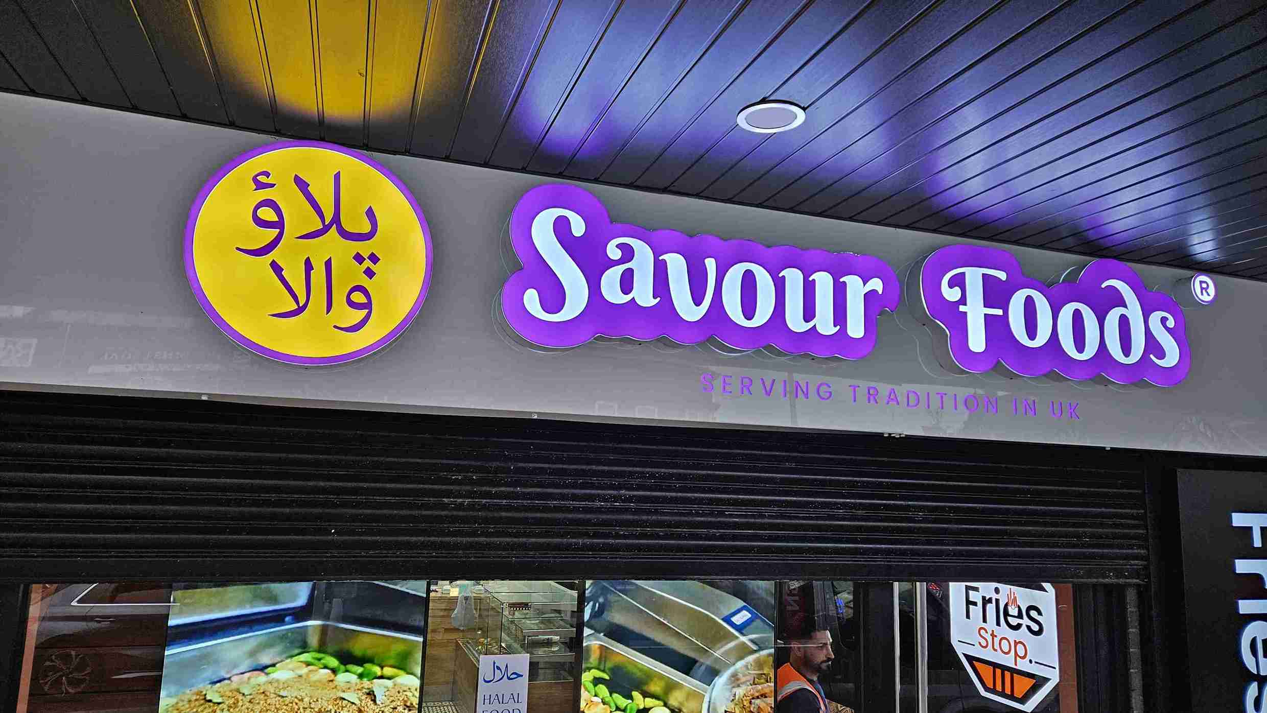 A welcoming store front with a prominent sign saying "Savour Foods," showcasing its food products.