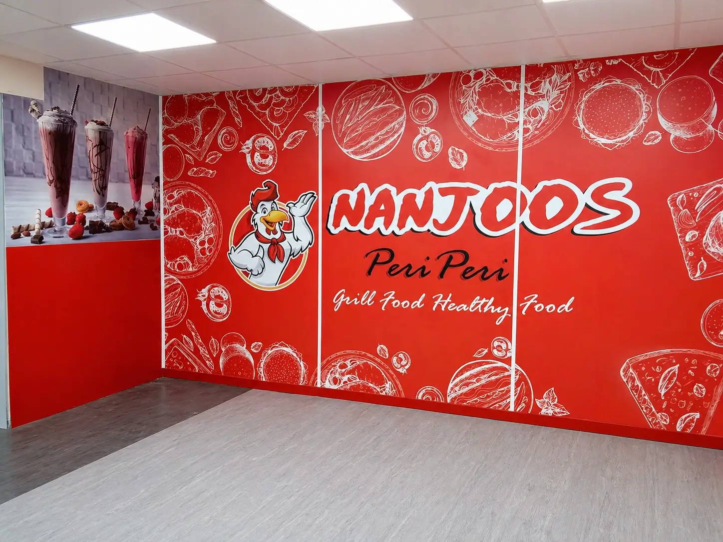 vibrant restaurant featuring a striking red wall and a prominent sign, inviting guests to dine inside